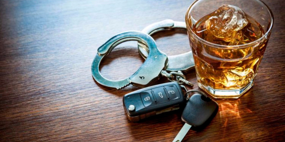 A pair of handcuffs, keys and car key on top of a table.